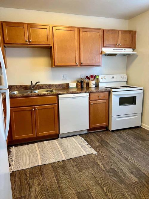 Kitchen Featuring Electric Range, Dishwasher & Refrigerator